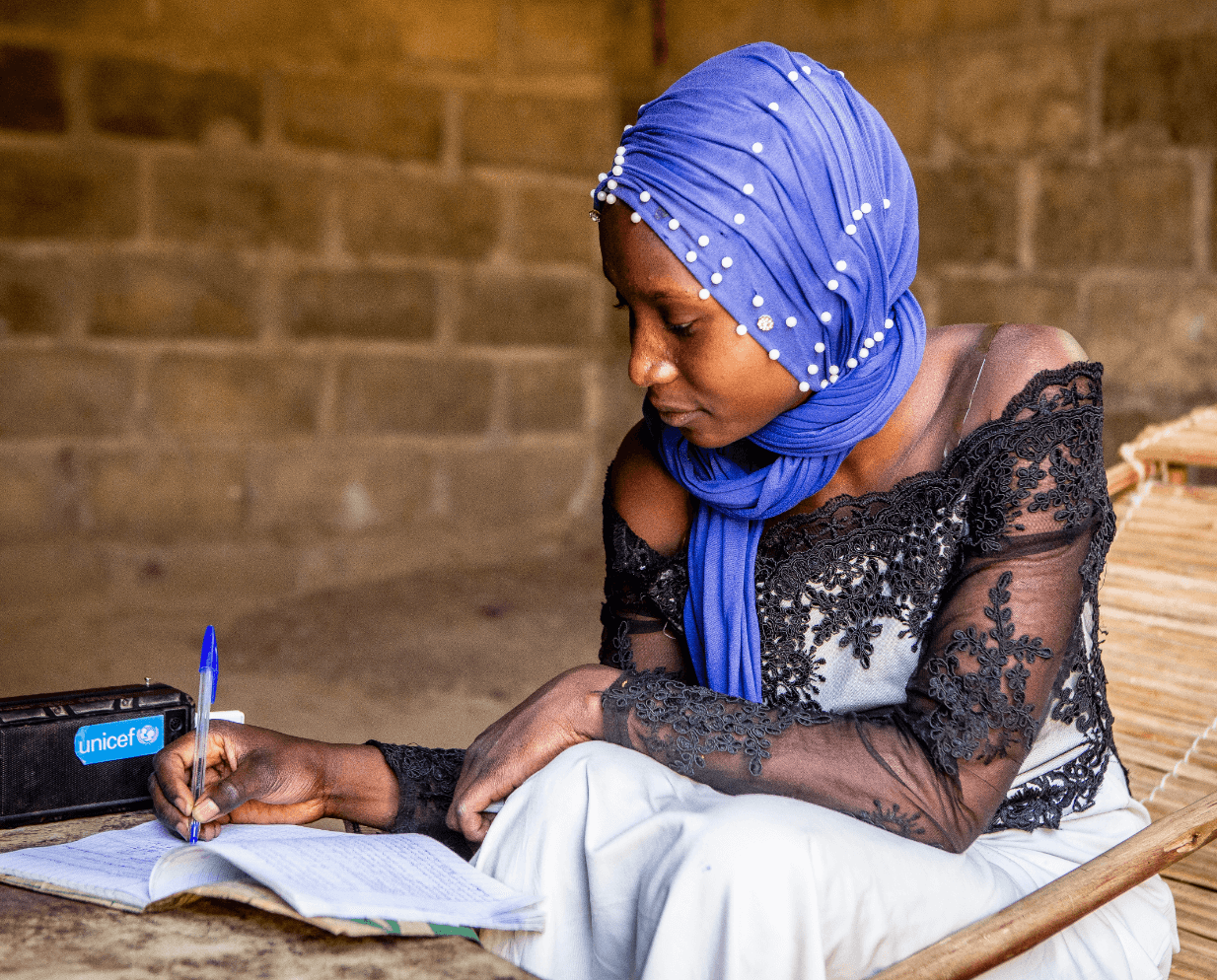 student doing schoolwork next to radio