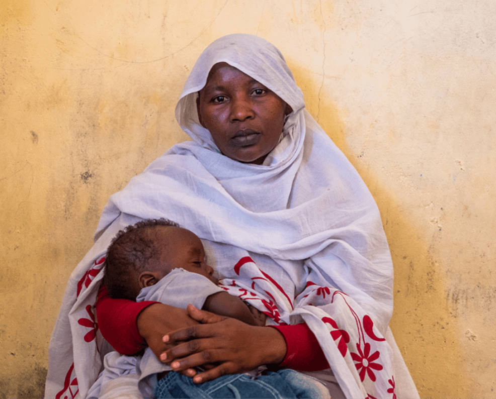 Mother with child sleeping in her arms