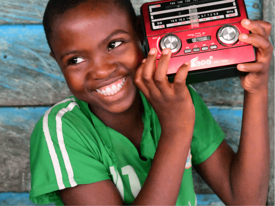 Girl listening to radio education and smiling