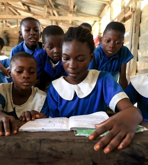 students looking at a notebook together