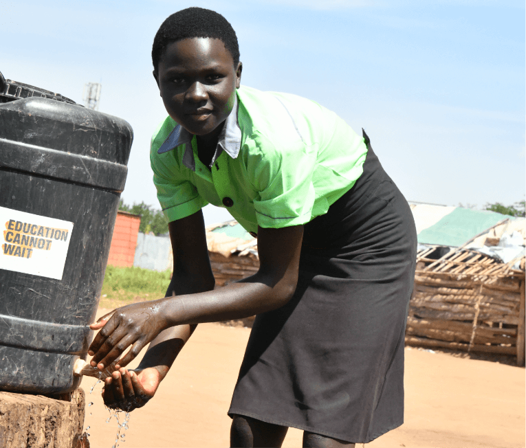 Student getting water from a water cooler