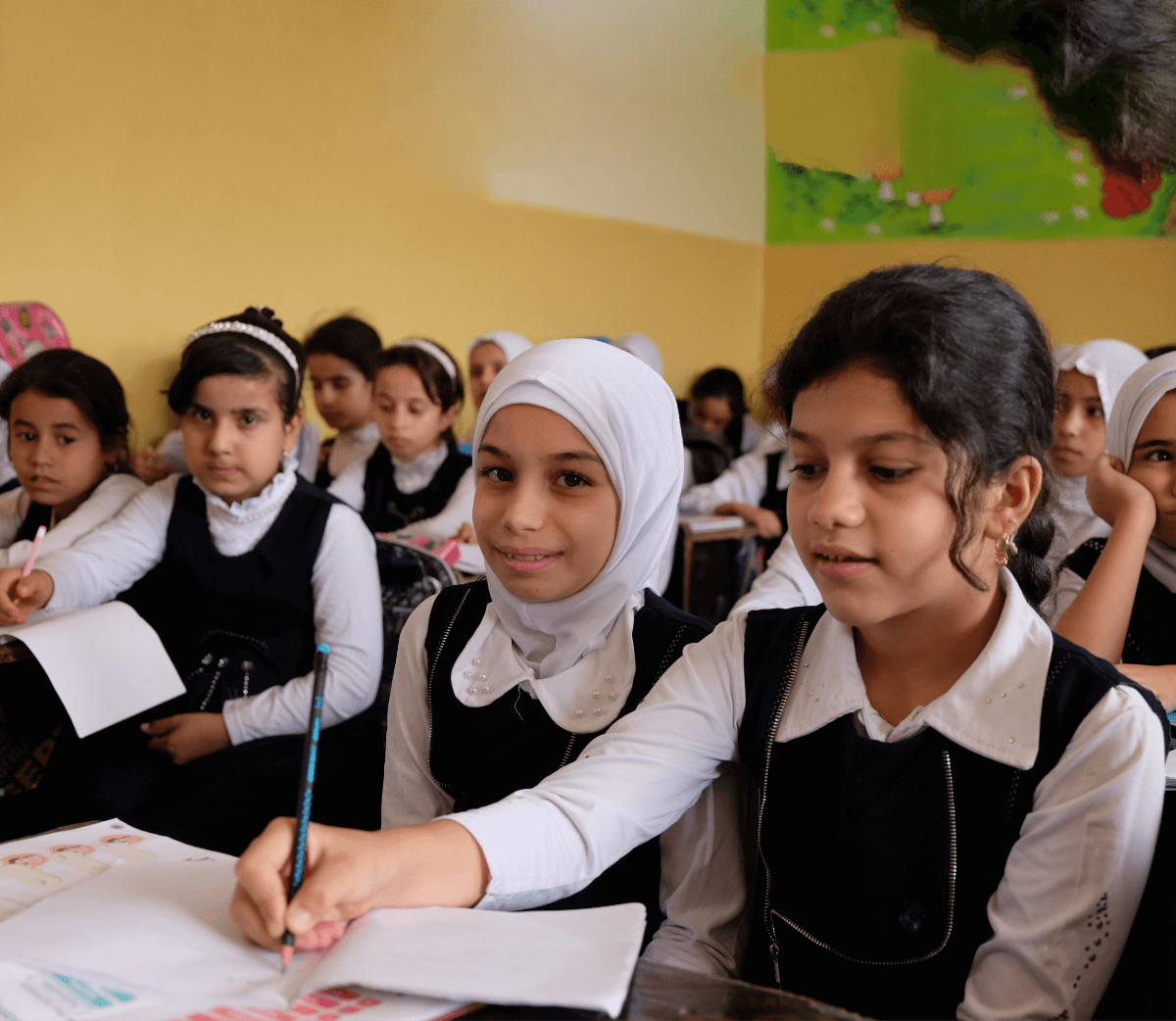 Students in school uniforms working in their classroom