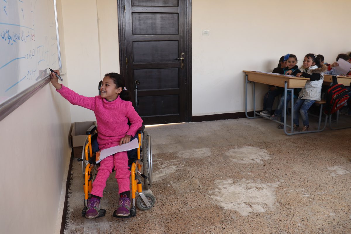 Hanaa, 8, who was paralysed by an exploding bomb and lost the use of her legs, solves a problem on a whiteboard in a classroom at a school in east Aleppo city, Syrian Arab Republic, February 2018. Hanaa's dream is to become a physiotherapist to help children like her. ©UNICEF/Al-Issa Hanaa, 8, who was paralysed by an exploding bomb and lost the use of her legs, solves a problem on a whiteboard in a classroom at a school in east Aleppo city, Syrian Arab Republic, February 2018. Hanaa's dream is to become a physiotherapist to help children like her. ©UNICEF/Al-Issa
