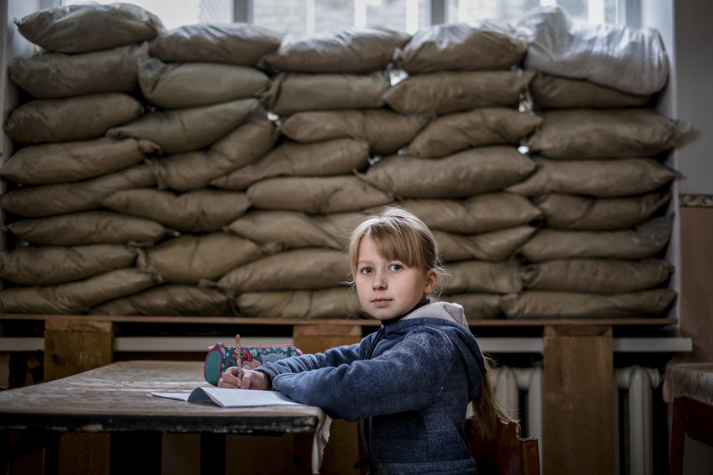 Girl sitting in a classroom in Ukraine.