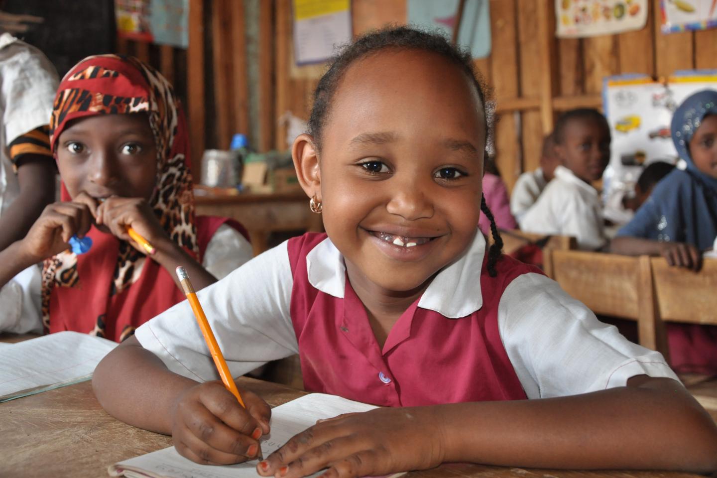 Girl attending class writing on her notebook