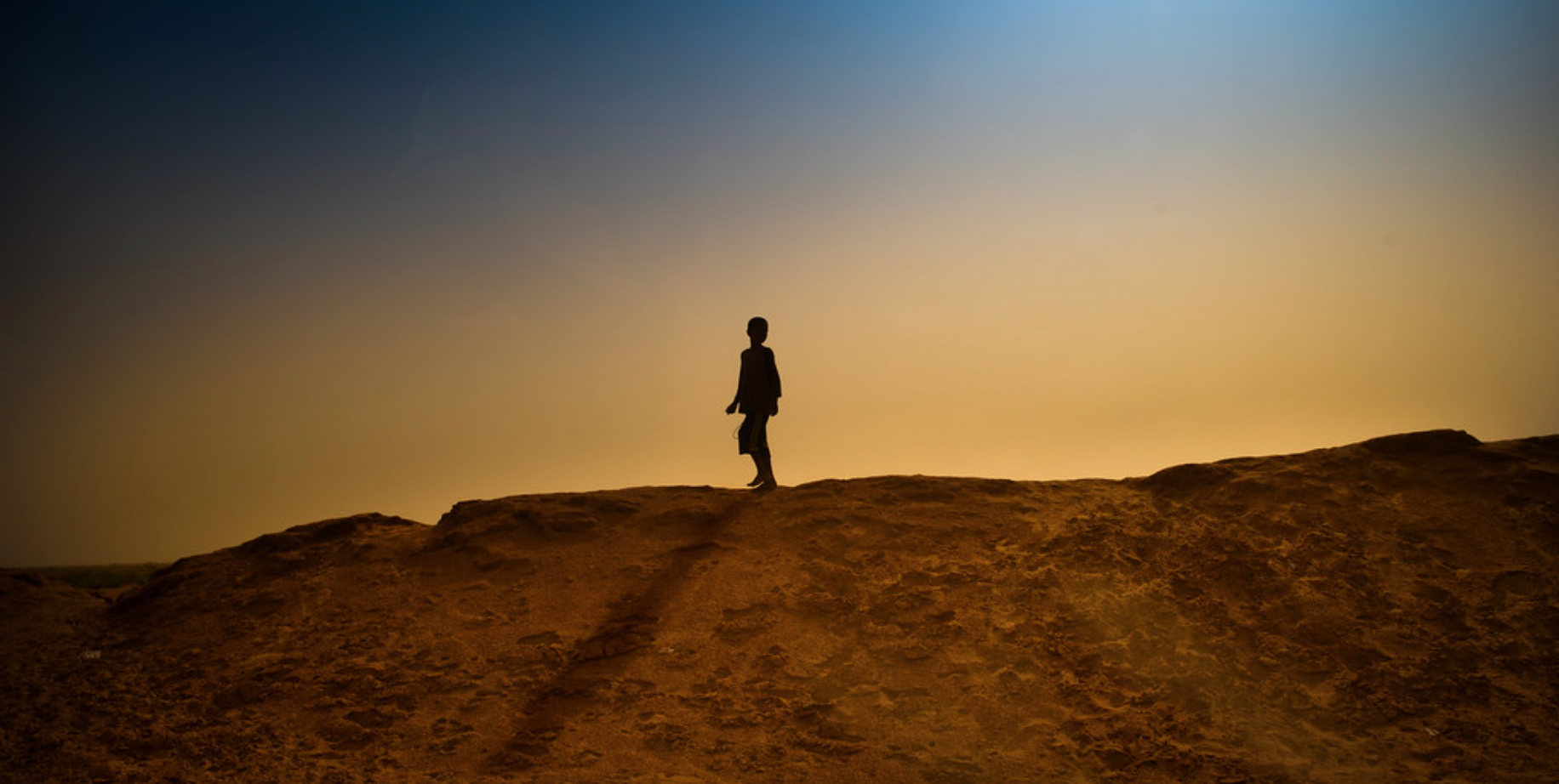 Child walking on a ridge outside. Child walking on a ridge outside.
