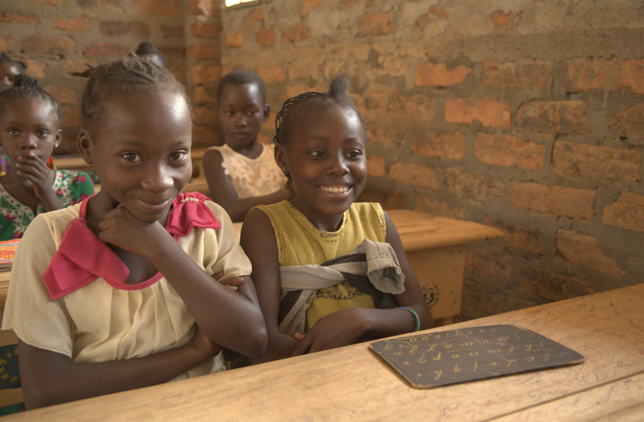 Girls sitting down attending class