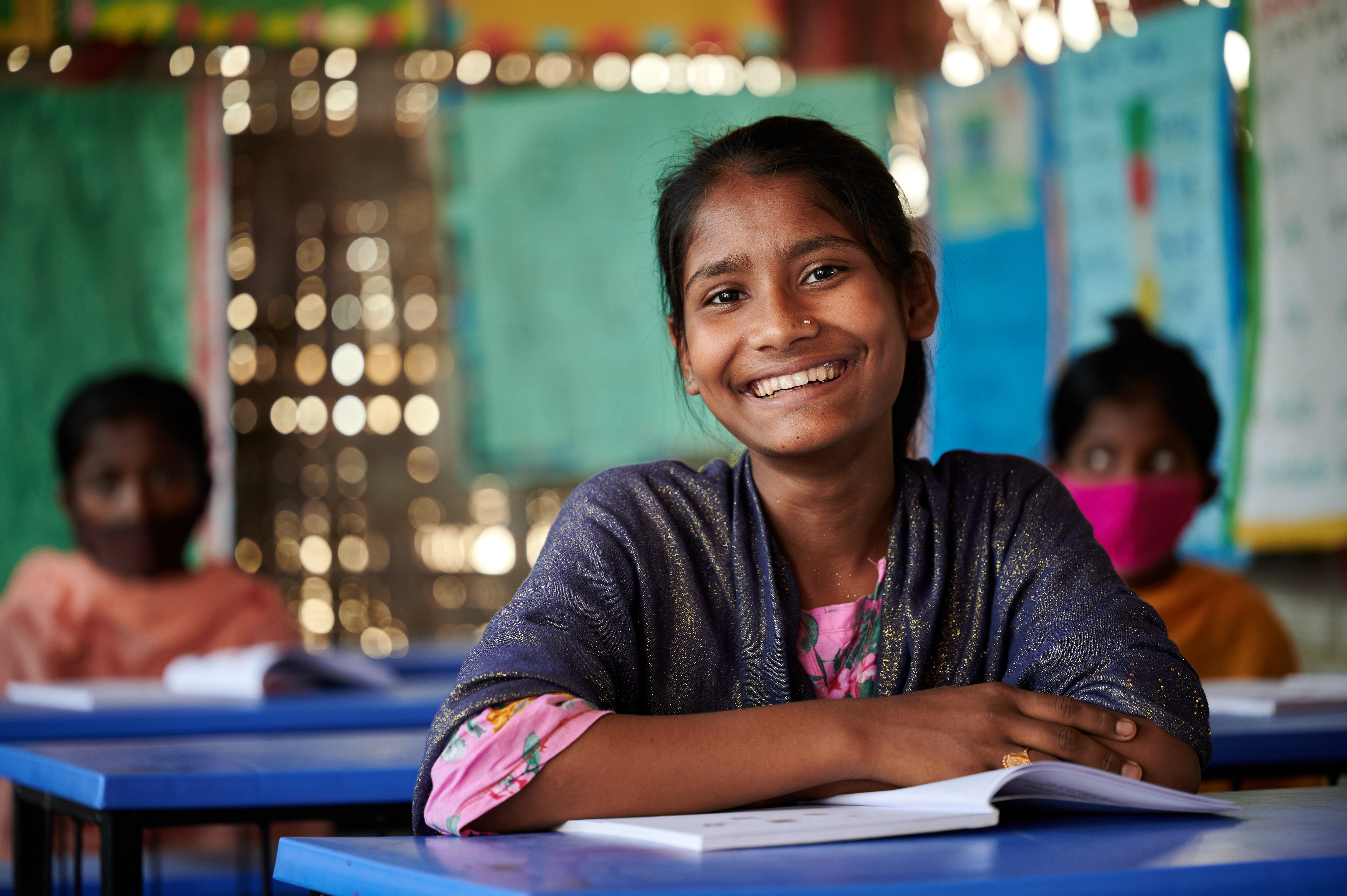 Rohingya refugee girl smiling at class