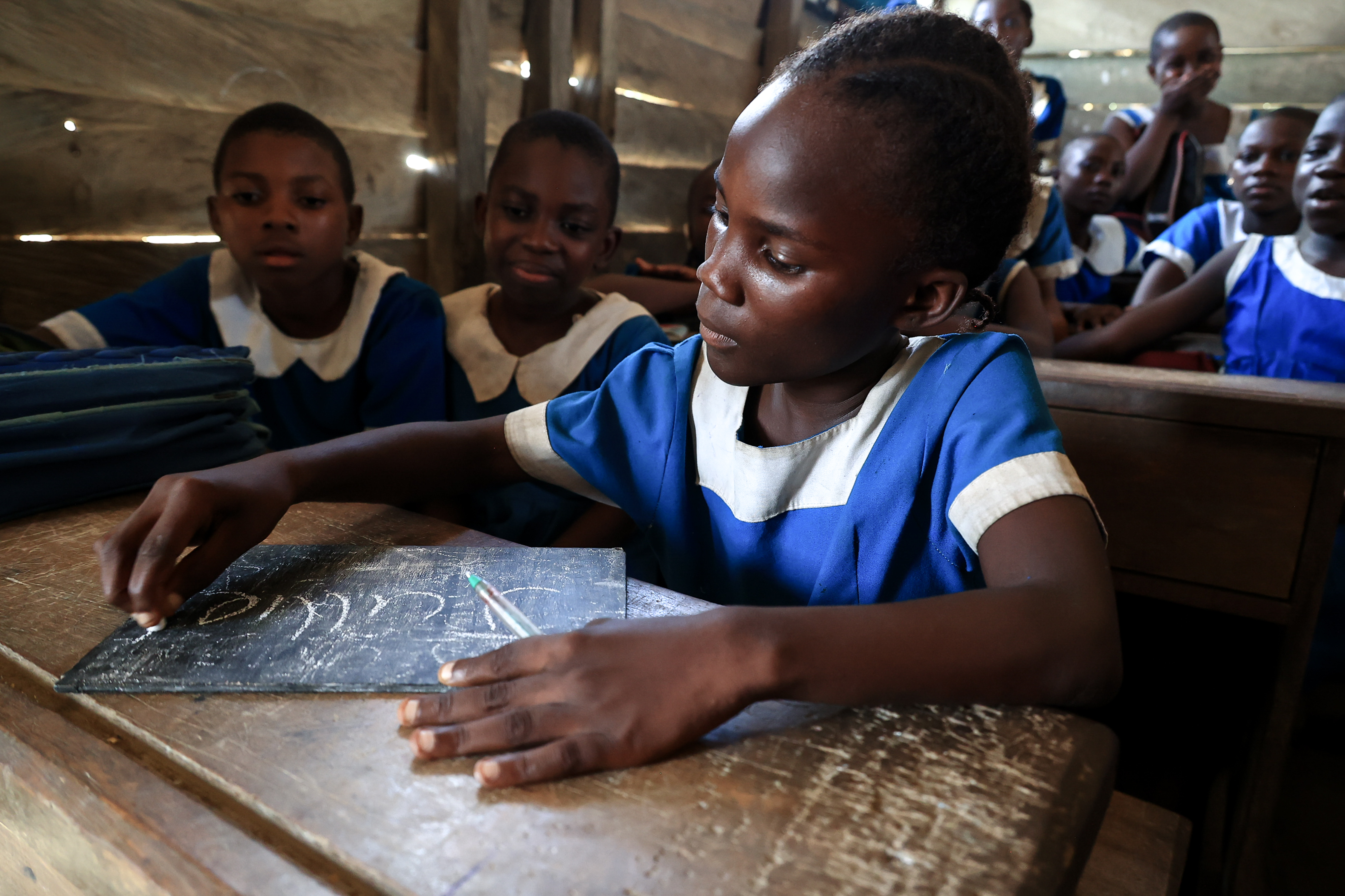Girl writing in Cameroon.