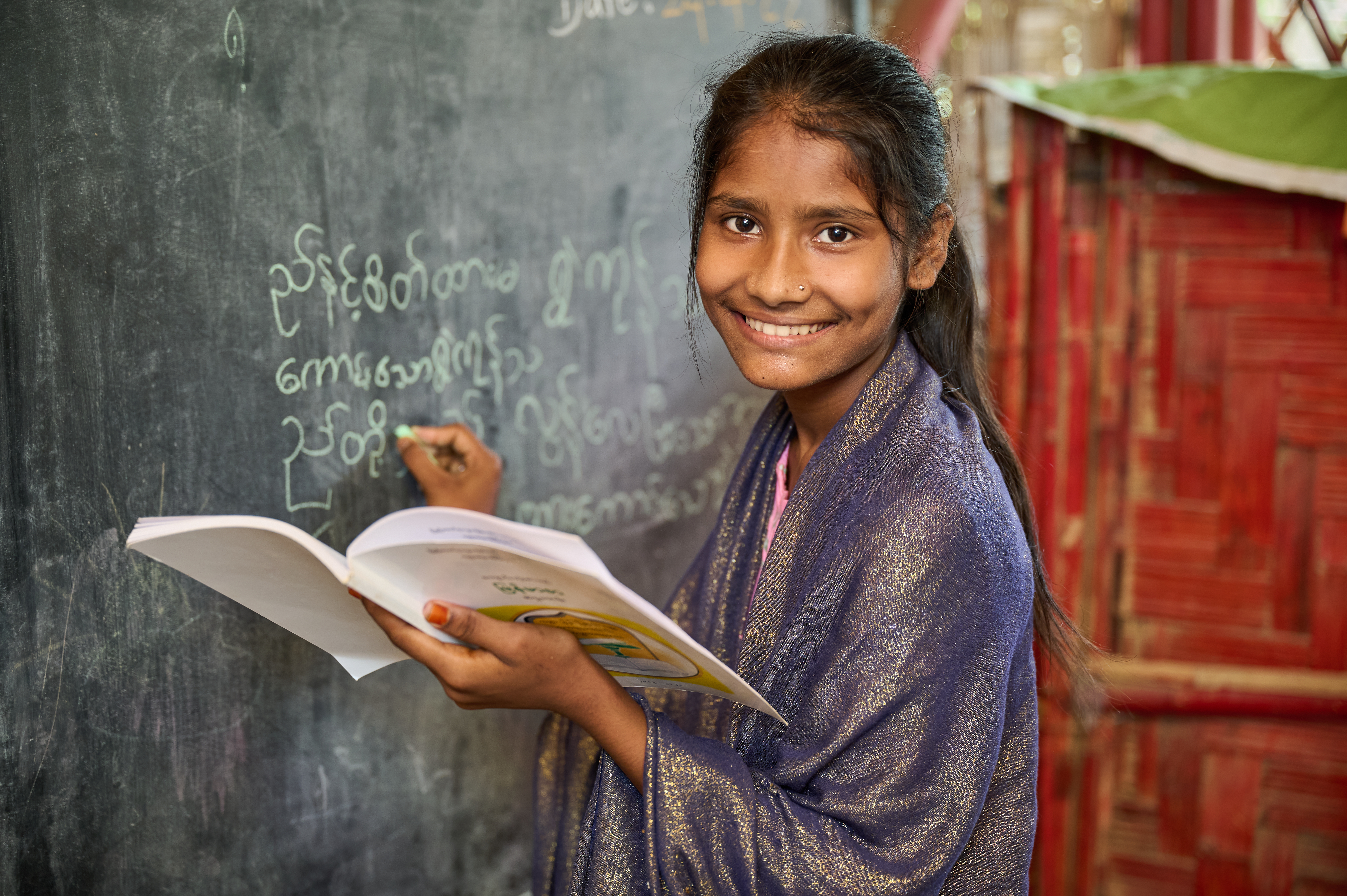 Girl writing on blackboard