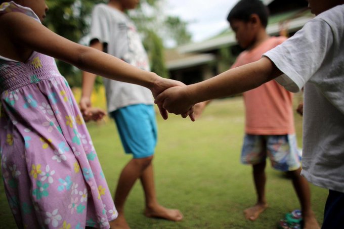 Children at playground holding hands Children at playground holding hands