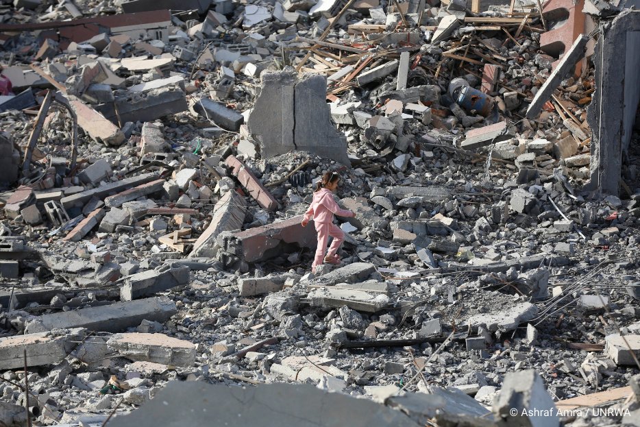 Girl walking through rubble in Gaza