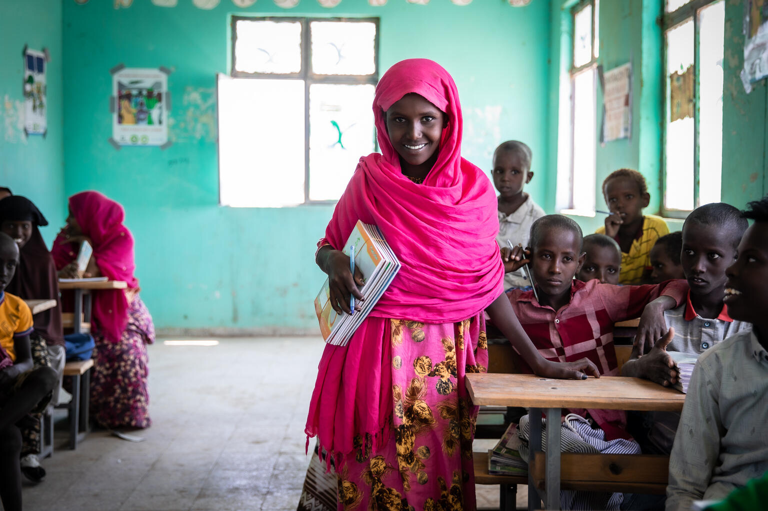 Girl posing for a picture at a classroom