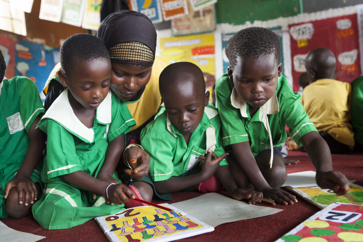 Children working with their teacher in Uganda.