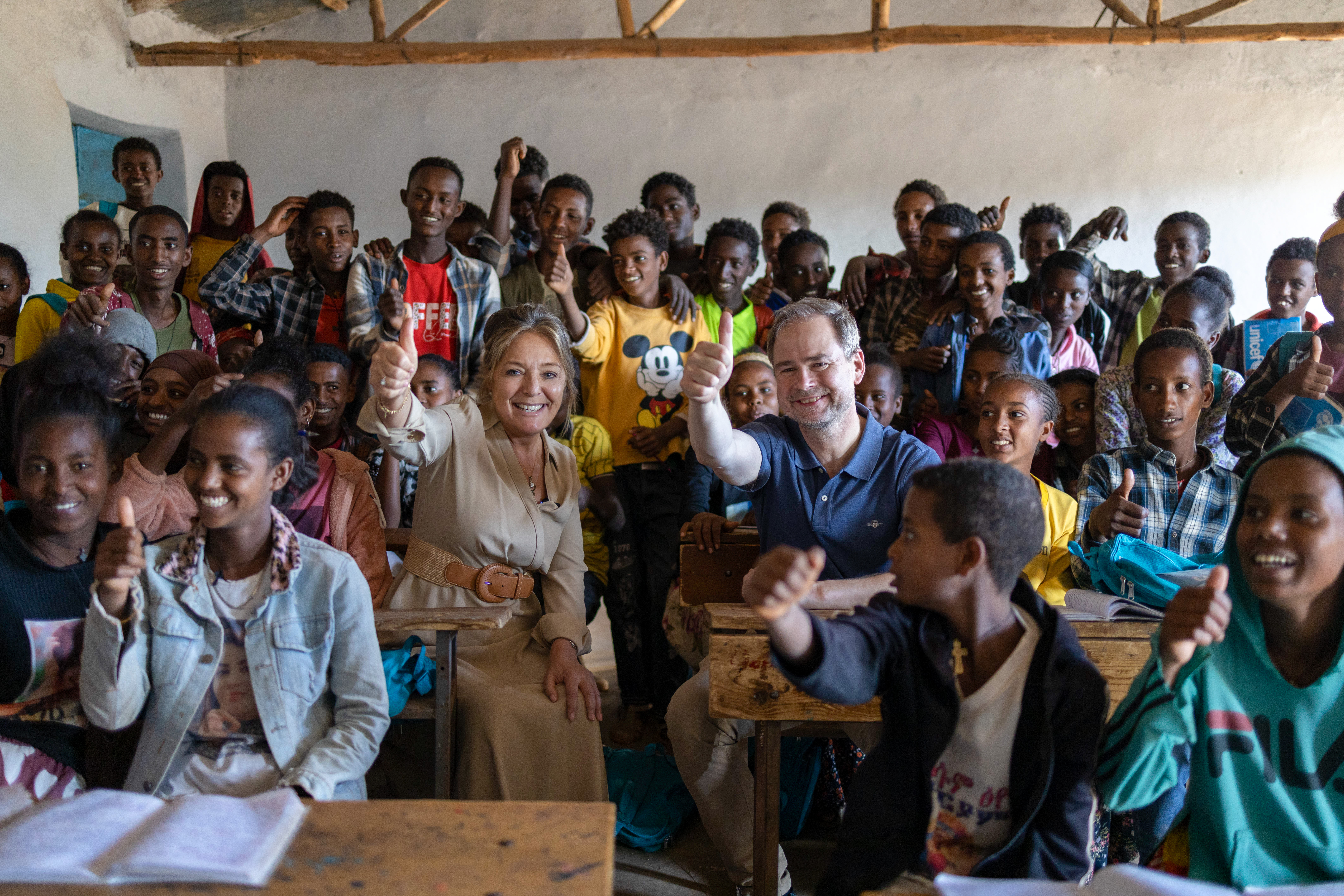 Yasmine Sherif and Nicolai Wammen at a school with children