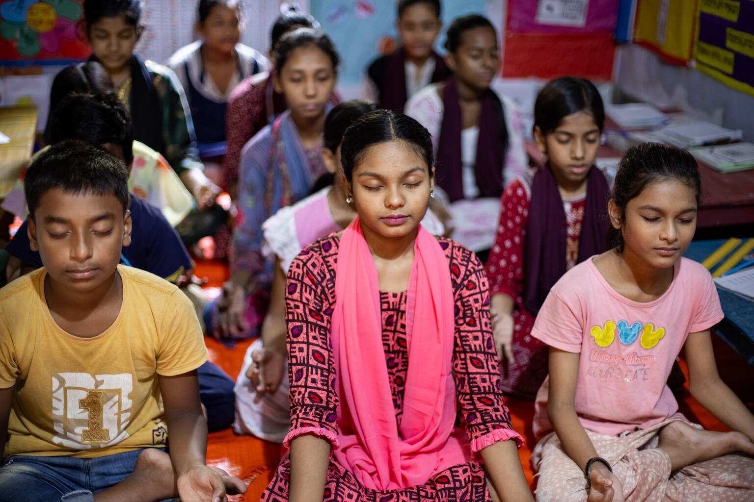 Schoolgirls meditating in a classroom in Bangladesh